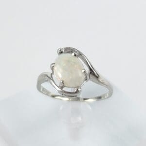 Silver ring with a white opal gemstone.