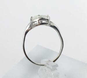 Silver ring with a gemstone side view.