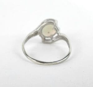 Silver ring with a round gemstone.