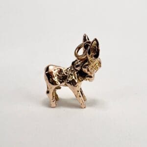 Bronze donkey charm on white background.