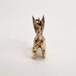 Golden donkey figurine with loop on top.