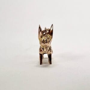 Gold animal figurine on white background.