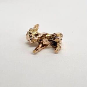 Golden rabbit figurine on a white background.