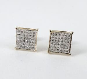 Square diamond stud earrings on display.