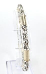 Silver and gold ornate bangle on display.