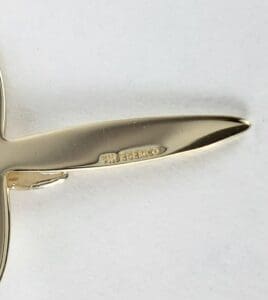 Gold-colored metal object with engraved text.