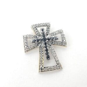 Cross pendant with black and white stones.