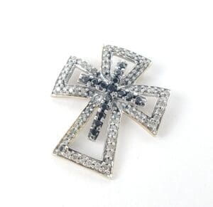 Silver cross pendant with black gemstones.