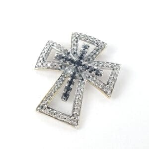 Silver cross pendant with black gemstones.