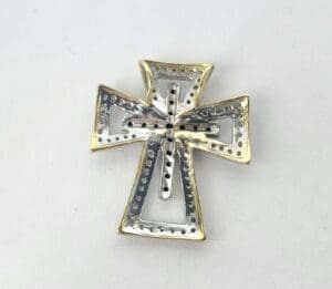 Silver and gold decorative cross pendant.