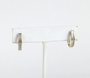 Gold hoop earrings with diamond accents displayed.