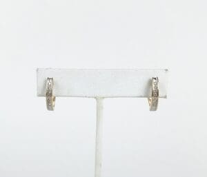 Gold hoop earrings with diamonds displayed.