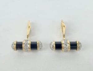 Gold and black cufflinks with diamonds.