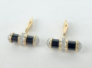 Gold and black earrings with diamonds.
