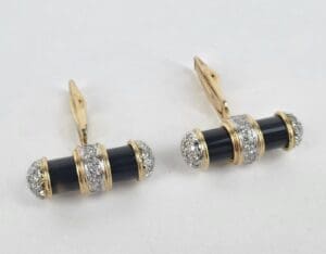 Gold and black cufflinks with diamonds.