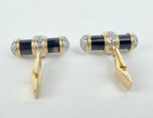 Gold and black cufflinks with silver accents.