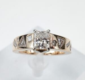 Gold ring with geometric diamond accents.