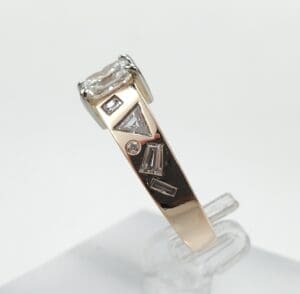 Gold ring with geometric diamond accents.