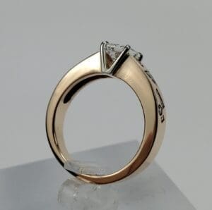 Gold ring with a diamond solitaire setting.