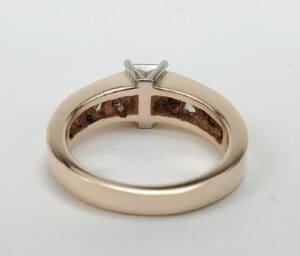 Gold ring with a solitaire diamond setting.