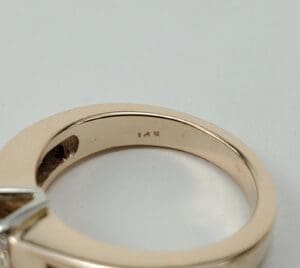 Gold ring with "14K" engraving inside band.