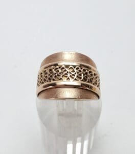 Gold ring with intricate filigree design.