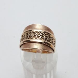 Gold ring with intricate filigree design.