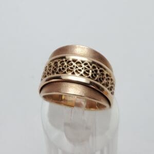 Gold ring with intricate filigree design.