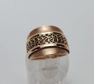Ornate gold ring with intricate filigree design.