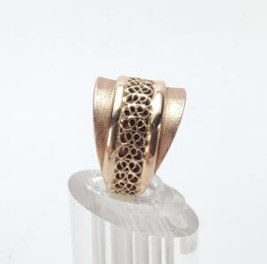 Gold ring with intricate filigree design.