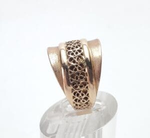 Gold ring with intricate filigree design.