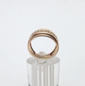Gold ring on transparent stand.