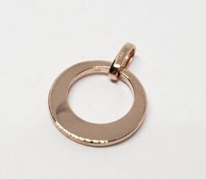 Gold circular pendant on white background.