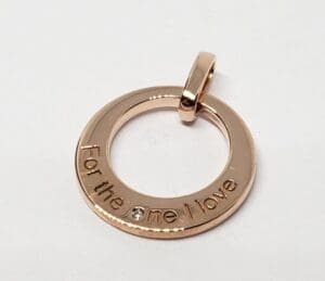 Gold pendant with engraved message.