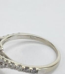 Silver ring with engraved initials "KT".