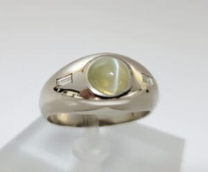 Silver ring with yellow gemstone and diamonds.