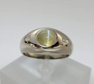 Silver ring with yellow gemstone center.