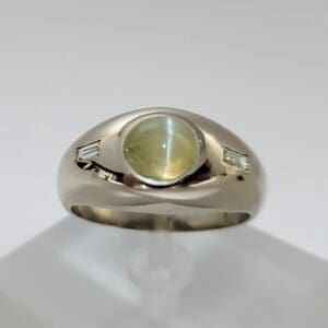 Silver ring with yellow gemstone center.