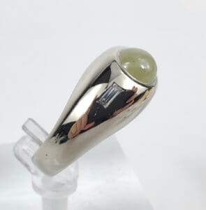 Silver ring with green gemstone cabochon.