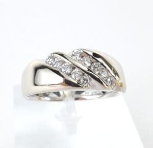 Silver ring with three rows of diamonds.