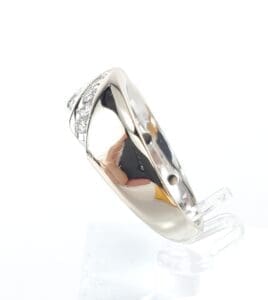 Silver ring with small embedded diamonds.