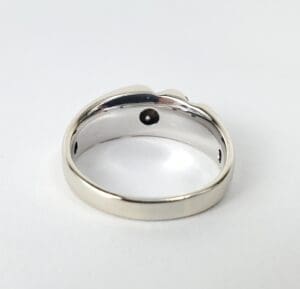 Silver ring with a black interior stone.