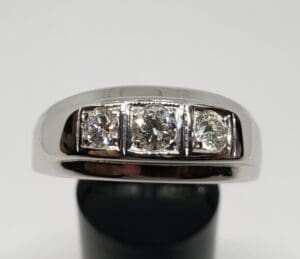 Silver ring with three sparkling diamonds.