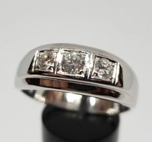 Silver ring with three square diamonds.