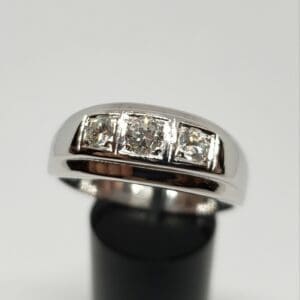 Silver ring with three square diamonds.