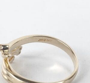 Gold ring with paw print design.