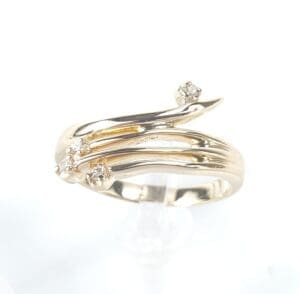 Gold ring with diamonds and curved design.