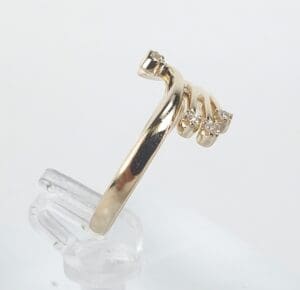 Gold ring with three diamond accents.