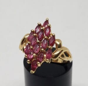 Gold ring with cluster of red stones.