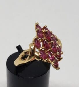 Gold ring with marquise-cut red stones.